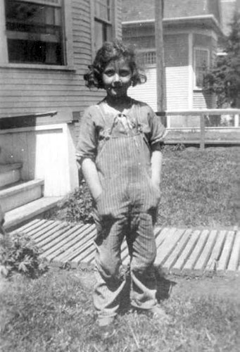 PK as child standing in front of house