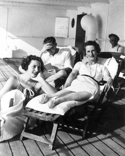 PK as young adult sitting with parents on ship deck